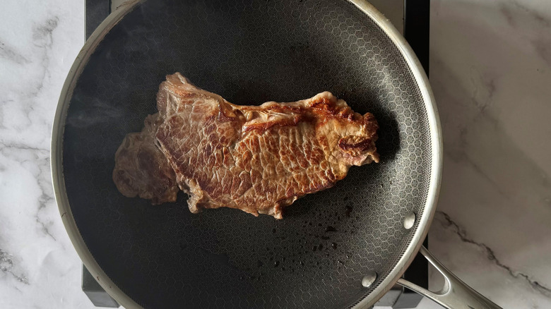 cooked steak in a frying pan