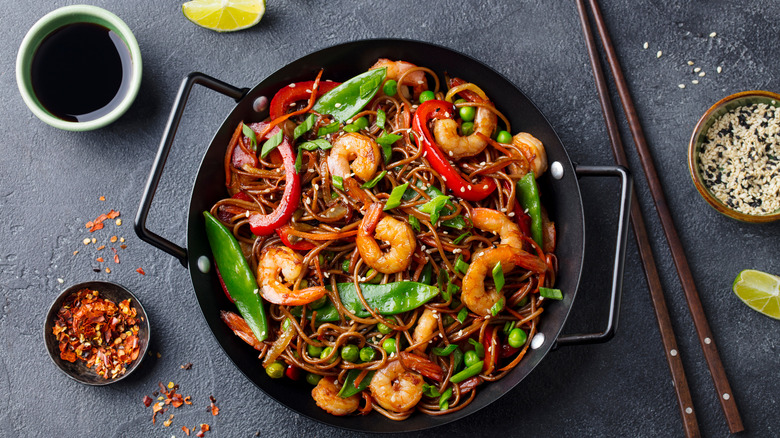 Stir fry noodles with shrimp and vegetables in a pot