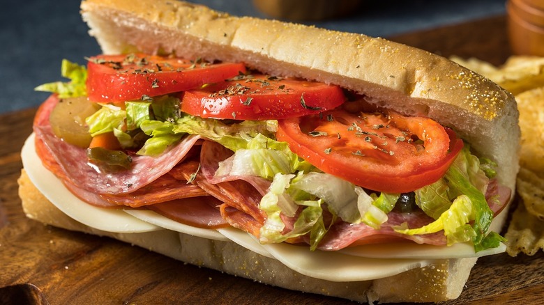 Italian sandwich with salami, provolone, and tomatoes