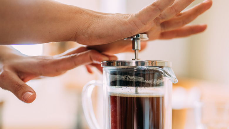 Woman using a French press