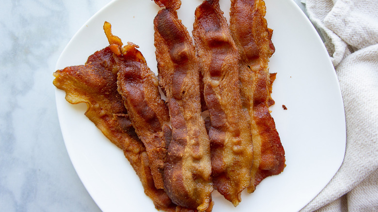 a white plate full of crisp bacon