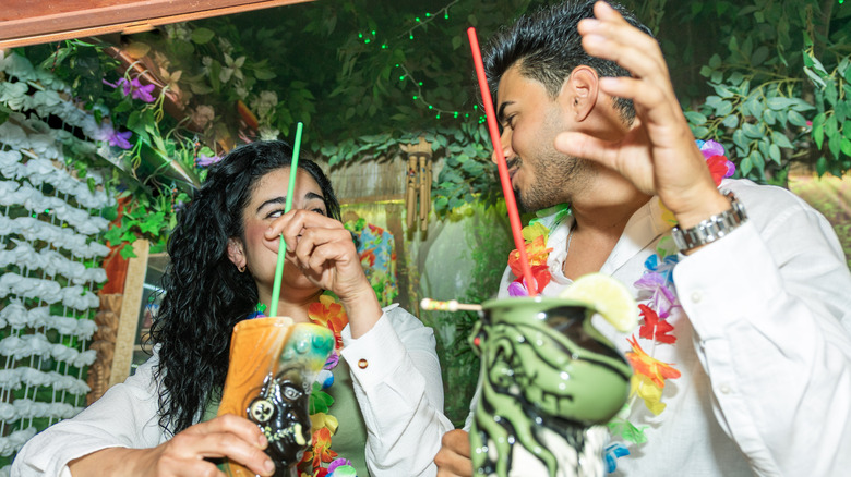 Customers at a tiki bar