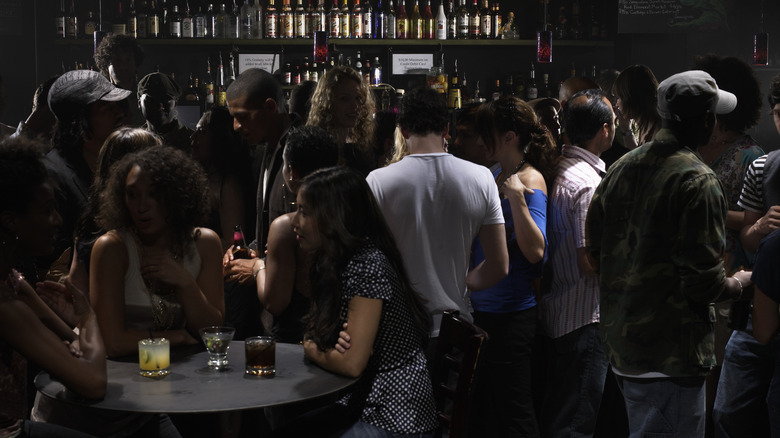 Customers in a busy cocktail bar