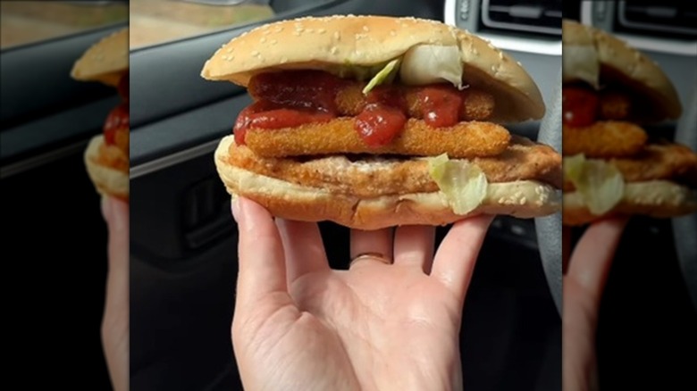 Hand holding a Burger King Chicken Parmesan sandwich hack