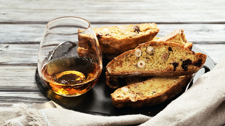 A glass of dessert wine and biscotti on plate