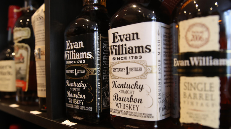 Various bottles of bourbon on a shelf in a store