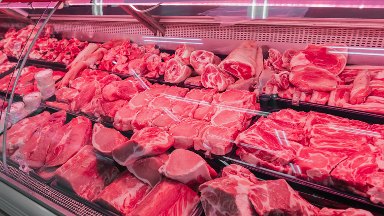 Grocery store display with different cuts of steak and other types of meat
