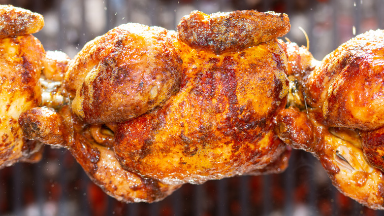 rotisserie chicken being cooked