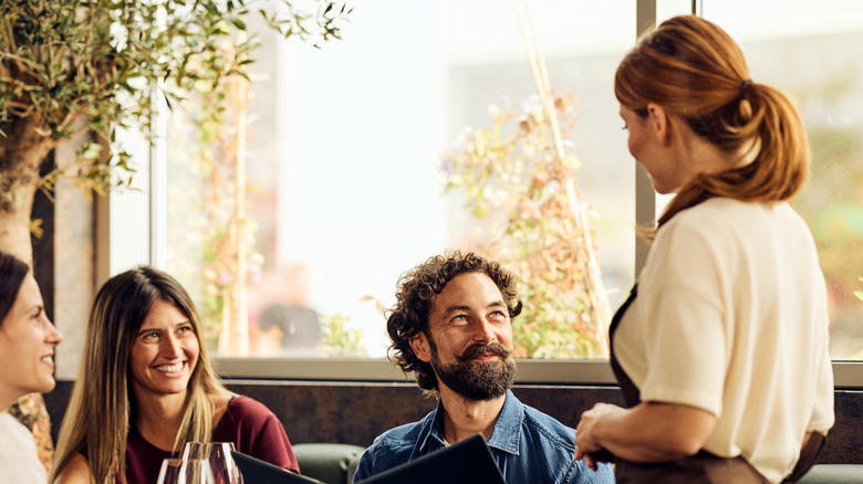 Diners and server making eye contact