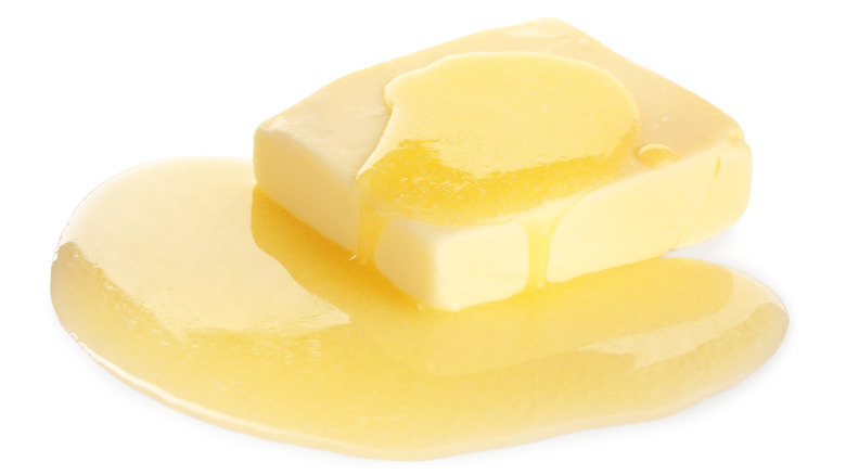 Butter melting against white background