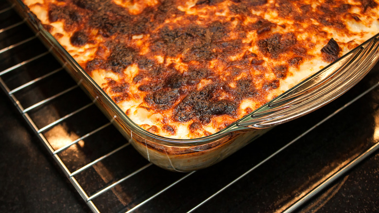 Lasagna in a glass dish in the oven