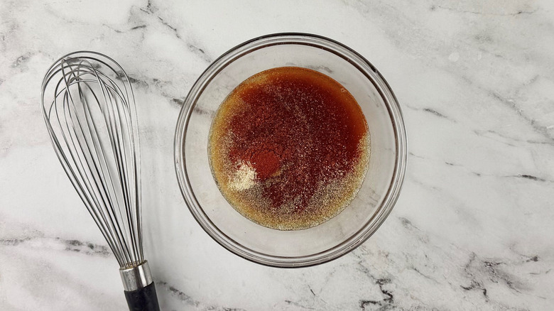 Marinade in bowl next to whisk