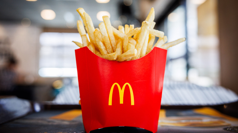 McDonald's french fries on table inside restaurant