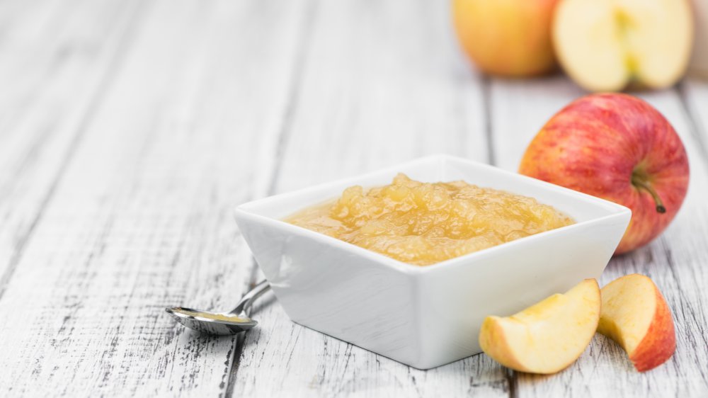 bowl of homemade applesauce with spoon and apple slices