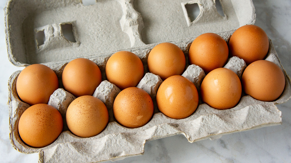 a dozen eggs in a carton