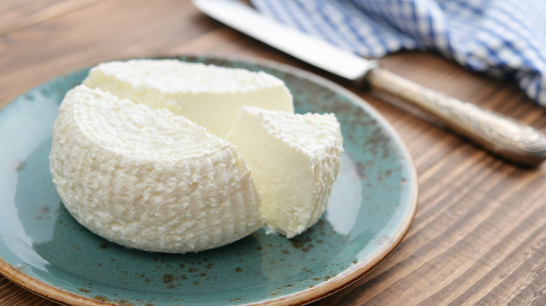 Ricotta cheese on a plate with knife 