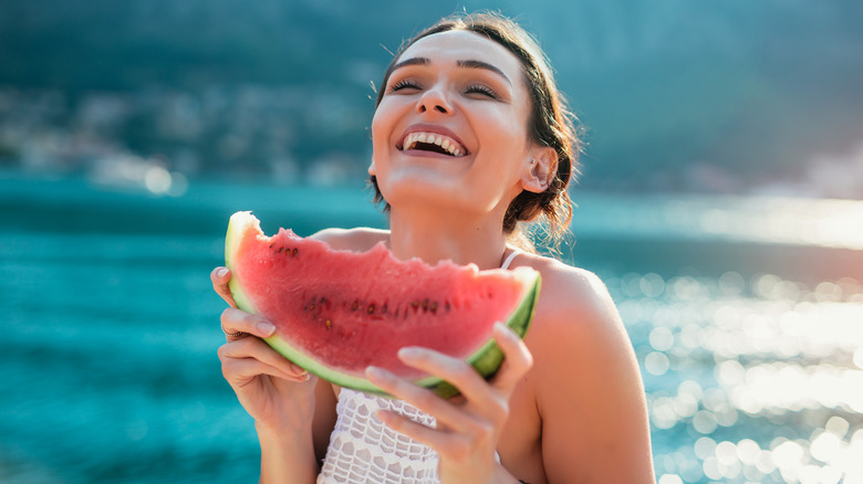 Lady enjoys eating waterrmelon