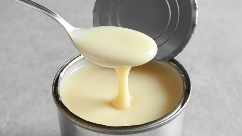 Spoon in can of evaporated milk