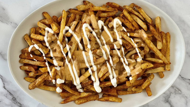fries with cheese sauce and ranch dressing