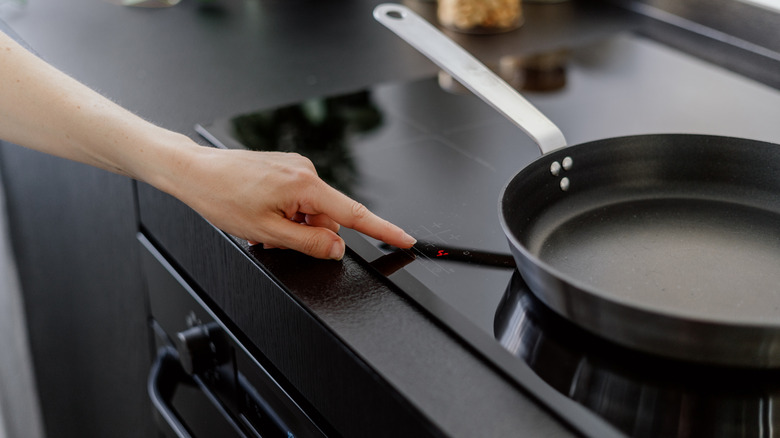 Person cooking on induction stovetop