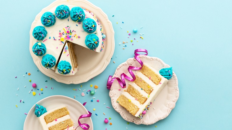 four layer white cake with white and blue icing