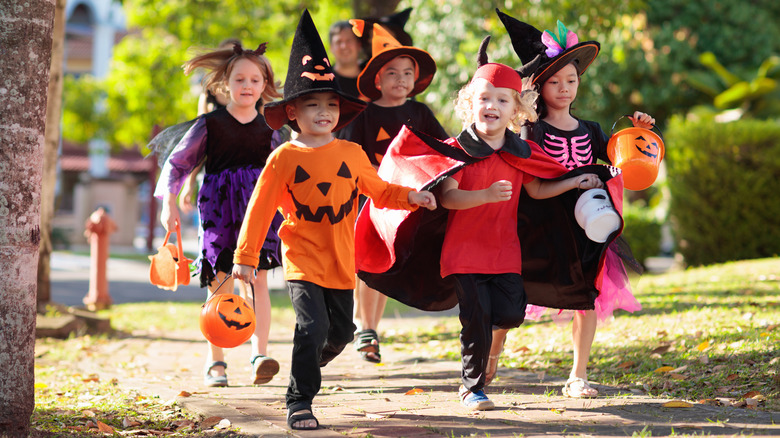 Kids trick-or-treating in costumes