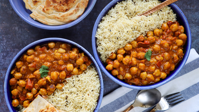 An aerial view of two plates of rice and chickpea stew