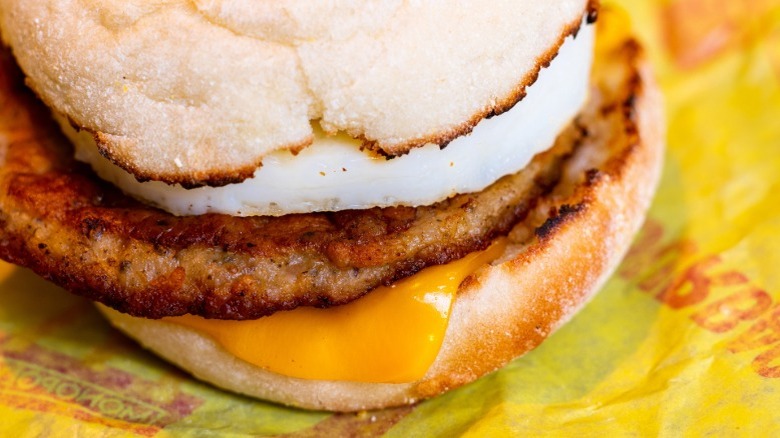 Sausage, egg, and cheese McMuffin on a yellow paper wrapper