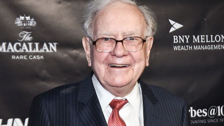 Warren Buffett smiling at a red carpet event