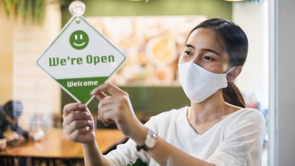 Woman with mask at restaurant