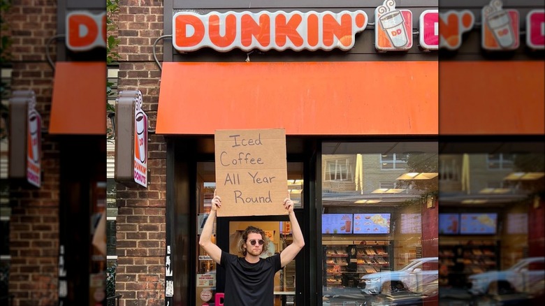 Dude with a Dunkn' sign