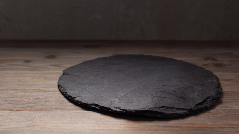 pizza stone on wooden table
