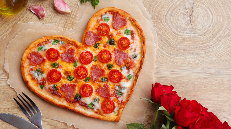 Heart-shaped pizza with tomatoes