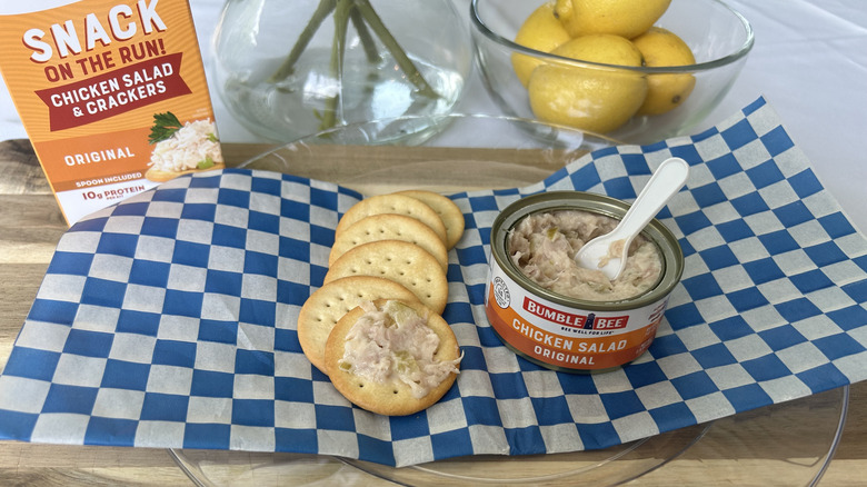 Bumble Bee chicken salad on a cracker with the can of chicken salad on the side