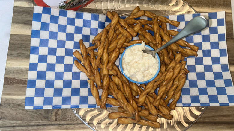 Reser's Chicken Salad in a bowl as a dip surrounded by pretzel sticks