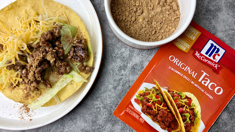 McCormick Original Taco Seasoning Mix packet, seasoning in a white ramekin, and a taco on a white plate