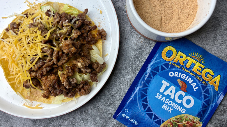 Ortega Original Taco Seasoning Mix packet, seasoning in a white ramekin, and a taco on a white plate