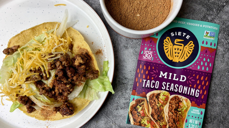 Siete Mild Taco Seasoning Mix packet, seasoning in a white ramekin, and taco on a white plate