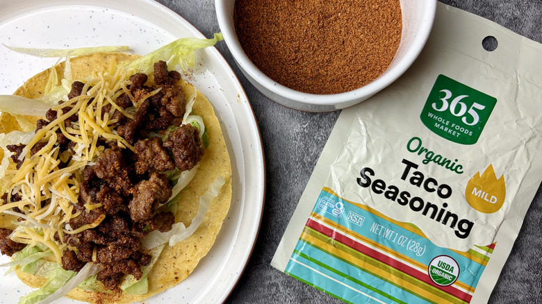 365 Whole Foods Market Organic Mild Taco Seasoning packet, seasoning in a white ramekin, and taco on a white plate