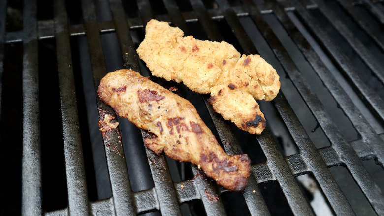 two chicken tenders on a grill