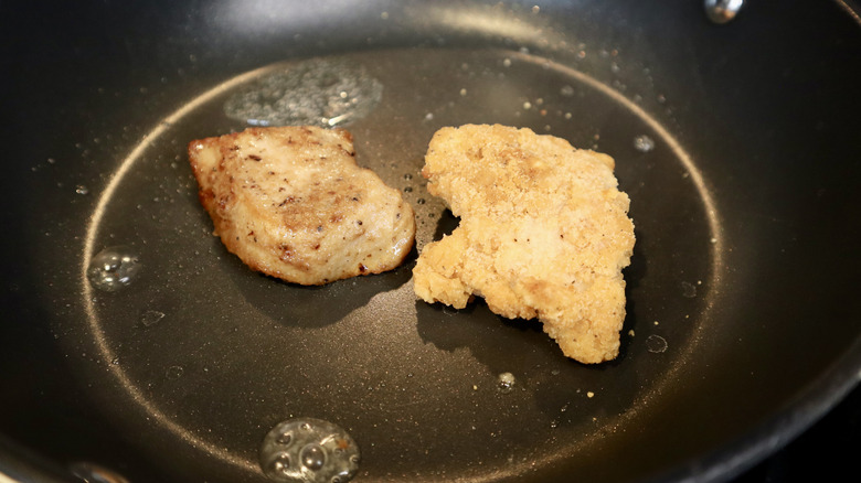 two chicken tenders on black pan