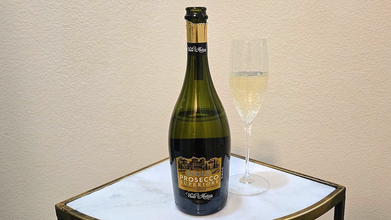 Villa Antica Prosecco Superiore Asolo DOCG and glass filled with wine on a marble table