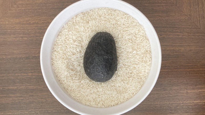 An avocado in a bowl of rice