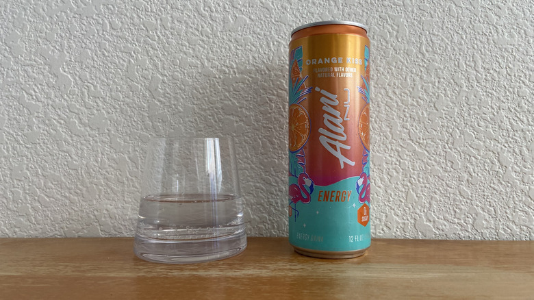 Orange Kiss can beside some poured into a small glass