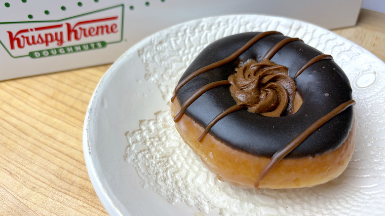 A Krispy Kreme Hershey's Double Chocolate Doughnut on a white plate