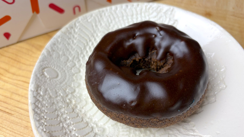 A Dunkin' Double Chocolate Donut on a plate