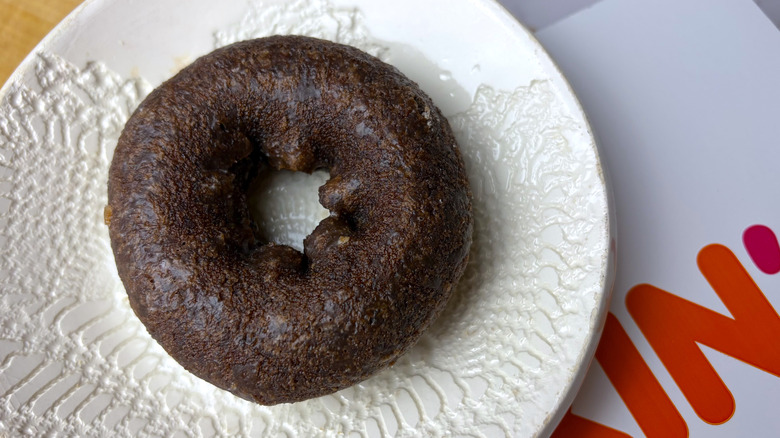 A Dunkin' Glazed Chocolate Donut on a plate