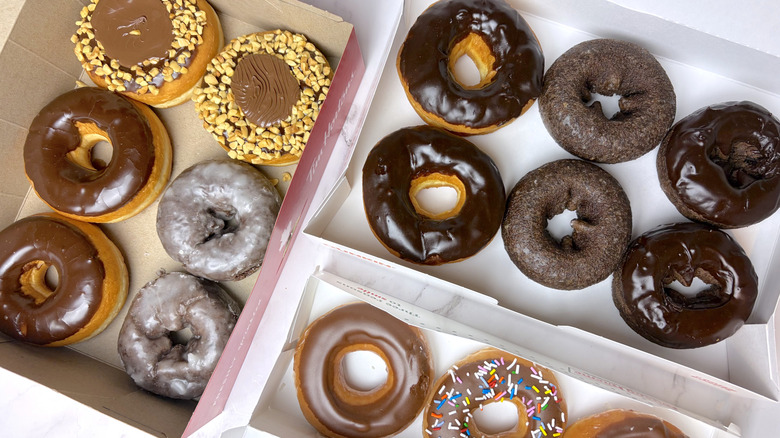 Boxes of chocolate donuts from Tim Hortons, Krispy Kreme, and Dunkin'