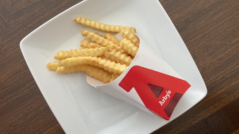 box of Arbys fries on plate