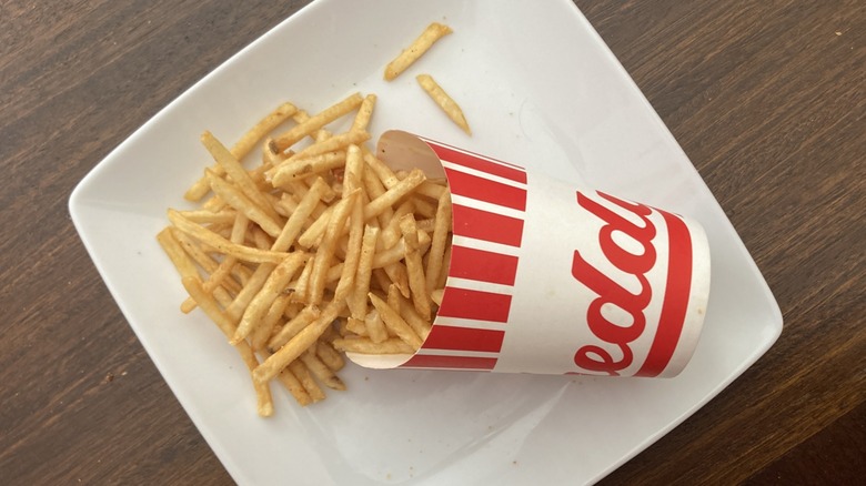 Freddys matchstick fries on white plate